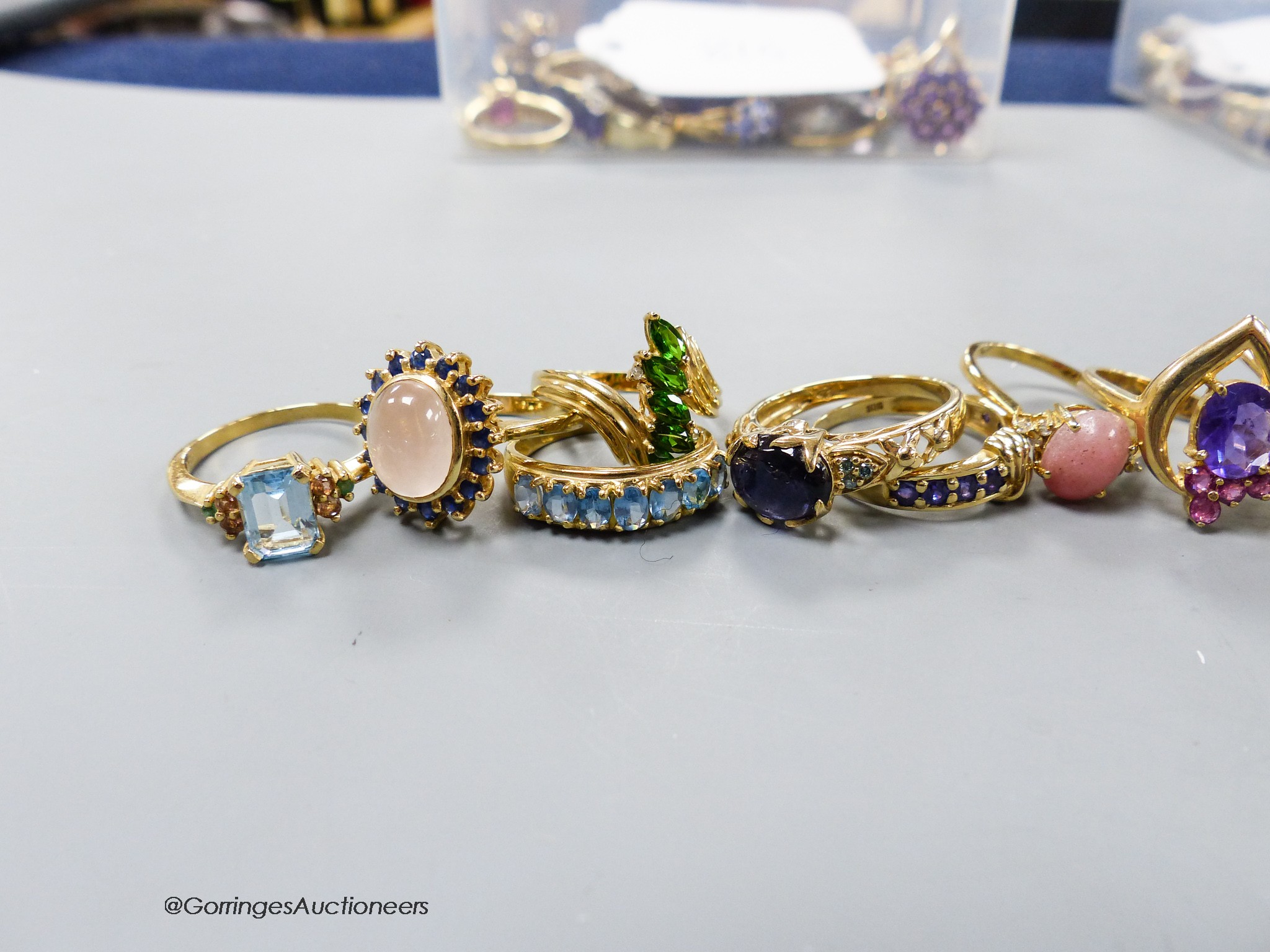 Fourteen assorted modern 10k yellow metal and gem set dress ring, gross 41.9 grams.